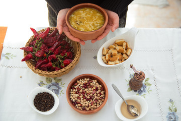 Erishde dish purple backgrounds . Erishde brown bowl . Vinegar on a small white bowl . Kesme, egg noodle , Kyrgyz, Azerbaijan cuisine, Traditional assorted dishes, Top view.