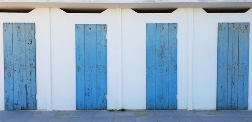 Obraz na płótnie Canvas Blue wooden doors arranged in a row.