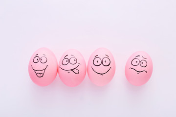 Funny pink eggs with face feeling on white background