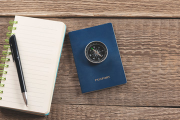 compass on passport on notepad