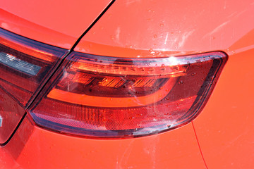 Close Up of Scratched Indicator Light on Red Car 