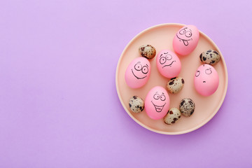 Funny pink eggs with face feeling on purple background