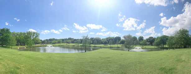 Large neighborhood park double water fountains pond near Dallas, Texas, USA cloud sky