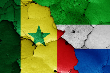 flags of Senegal and Sierra Leone painted on cracked wall