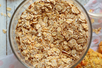 Oatmeal in a jar, top view, close-up. Homemade oatmeal cookies. Light background