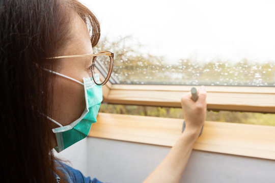 Woman Wearing Facial Medical Mask Opening Window In A Sunny Day