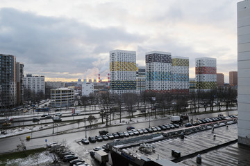 The outskirts of Moscow in early spring. View from the window of the city, on the Warsaw highway, multi-storey buildings and pipes of the CHP. Few people, start of quarantine
