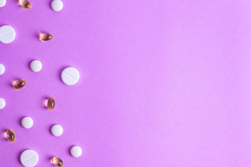 Pills on the background from different diseases human therapy on a purple background