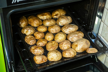 Baked potato halfs in a hot roasting platter fresh from the oven