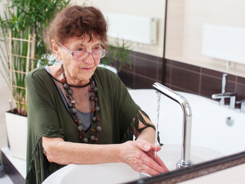 Elderly Old Woman Washes Her Hands