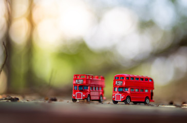 toys that represent two of the main symbols of the city of London, double-decker bus on blurred background. selective focus and grain nose.