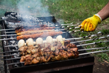BBQ barbecue skewers meat skewers with mushrooms on a flaming grill