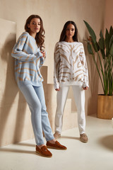 Two beautiful brunette woman natural makeup wear fashion clothes casual dress code style knitted...