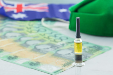 100 Australian dollars, Green mask syringe economic crisis Health expenses Corona virus outbreak. The idea is to spend a lot of money on inventing vaccines to prevent epidemics..
