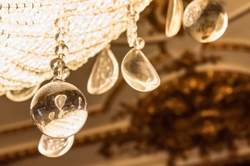 Detail of light reflection on glass pearls of old crystal chandelier