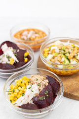 Mixed salads with avocado corn beans beet and onions in bowls