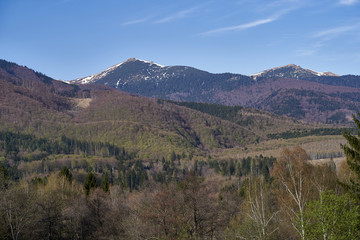 Scenic view of big mountain. Big mountains with snowy peaks, blue sky during sunny day. Nature and travel concept.