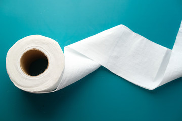 close up of roll of toilet paper on green background 
