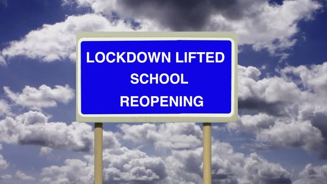 Education schools and Covid-19. Coronavirus Lockdown Lifted School Reopening sign with a timelapse of white clouds and blue sky.  Corona covid.