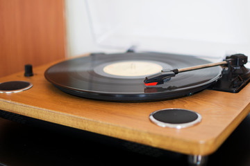 A wooden record player playing a vinyl cd.
