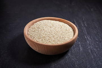 Sesame seeds and bowl on a dark table. Healthy food and drink concept. Top View.