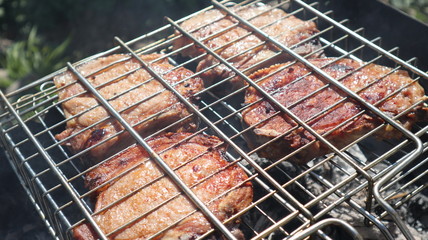Pork steaks cooked on a charcoal grill outdoors