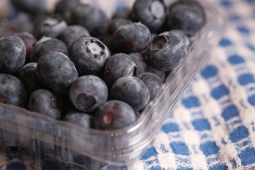Close up of fresh blue berry on table cloth.