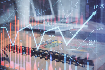 Double exposure of financial graph drawings and desk with open notebook background. Concept of forex market