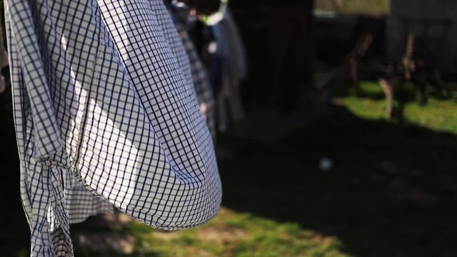 clean washed clothes hanging outside in the wind