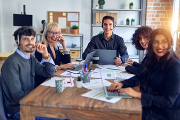 Group of call center workers smiling happy and confident. Working together with smile on face using headset at the office.