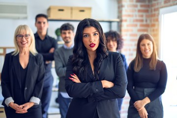 Obraz premium Group of business workers smiling happy and confident. Posing together with smile on face looking at the camera, young beautiful woman with crossed arms at the office
