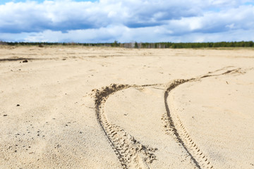 bike or bicycle tracks in the sand close up