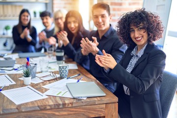 Group of business workers smiling happy and confident. Working together with smile on face looking at the camera applauding at the office