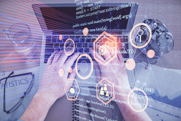 Double exposure of man's hands typing over computer keyboard and data theme hologram drawing. Top...