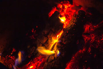 Fototapeta na wymiar Coals in a campfire blurry close up with long exposure