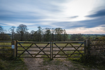 Old Rustic Farm Gate in front of a beautiful landscape of the  Yorkshire countryside at dusk