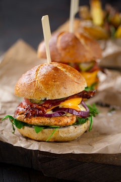 tasty looking homemade chicken burgers with cheese and bacon
