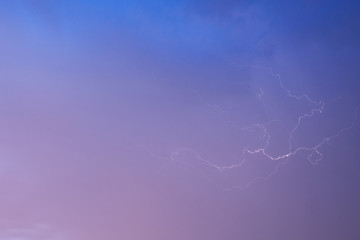 Lightning on a pink blue sky
