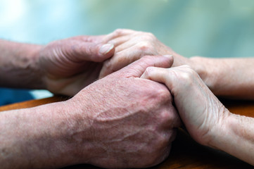 Fototapeta premium senior family couple holding old hands, psychological support concept