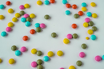 colorful medication and candies on white background