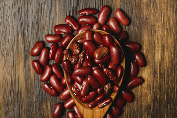 dried beans in wooden spoons on the table, close up