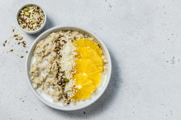 Vanilla citrus coconut overnight oatmeal. Top view, copy space.