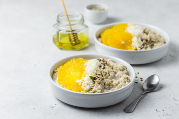 Healthy vegan breakfast, citrus seeds oatmeal. Selective focus, copy space.