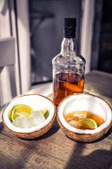 Rum with ice and coconut, a bottle of rum with lime