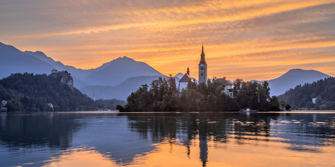 Lake bled with church under orange sky