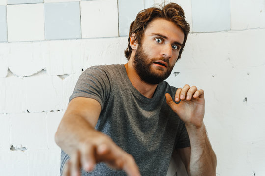 Portrait of Expressive young  bearded man scared and nervous