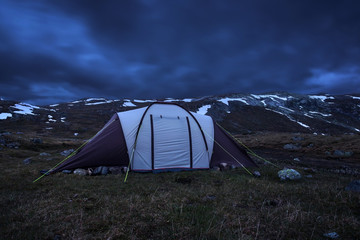 Big tent on the background of mountains with snow, night, spring in the Norwegian mountains © gerados