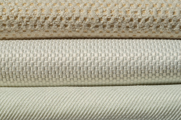 Catalog of fabric in white beige shades. Fabric sample. Industry background.