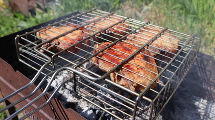 Pork steaks cooked on a charcoal grill outdoors