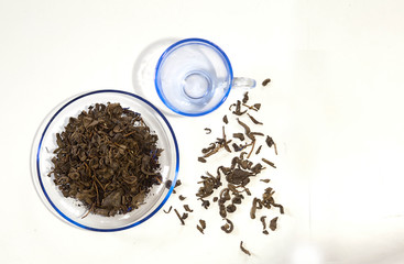 dry tea leaf and cup  on a white background
